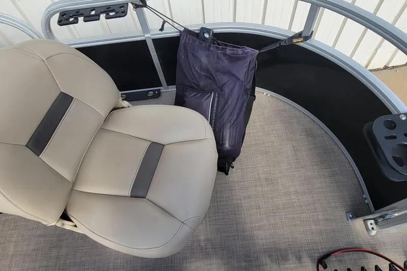 Slide: The Image of 2022 SUNTRACKER BASS BUGGY 16 XLS interior with beige seating and storage bag. - 27