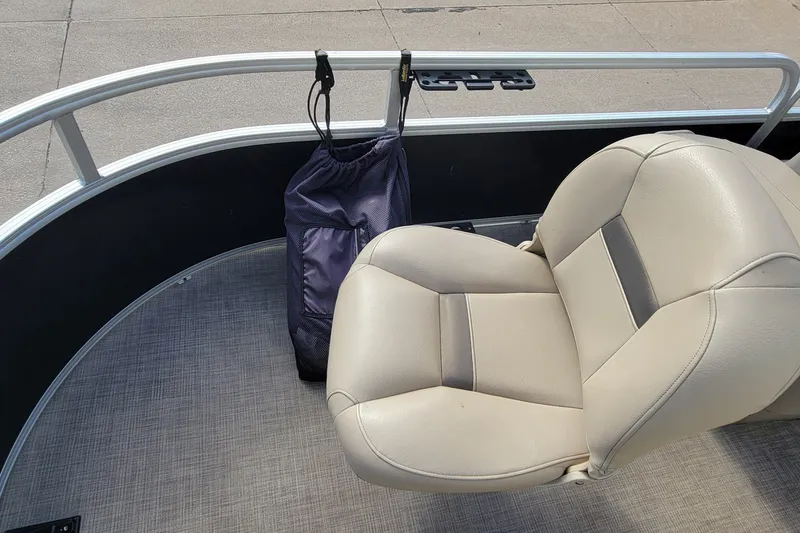 Slide: The Image of 2022 SUNTRACKER BASS BUGGY 16 XLS boat interior with beige seat and storage bag. - 28