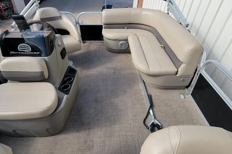 Slide: The Image of 2022 SUNTRACKER BASS BUGGY 16 XLS interior with beige seating and carpeted floor. - 29