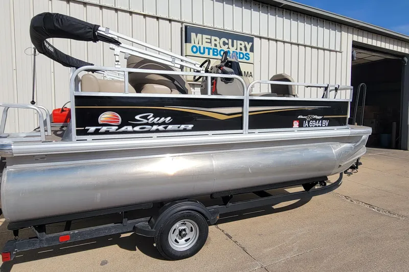 Slide: The Image of 2022 SUNTRACKER BASS BUGGY 16 XLS pontoon boat on trailer outside dealership. - 3