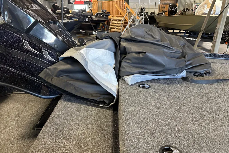 Slide: The Image of Boat interior with folded cover on Nitro Z18 Pro, 2021 model, in showroom setting. - 16