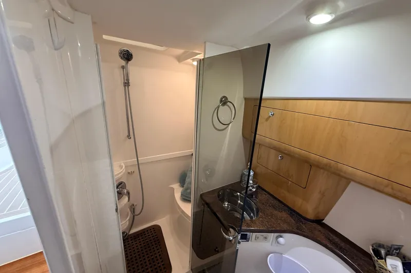 Slide: The Image of Bathroom interior of 2016 Intrepid 430 Sport Yacht with shower and wooden cabinetry. - 10