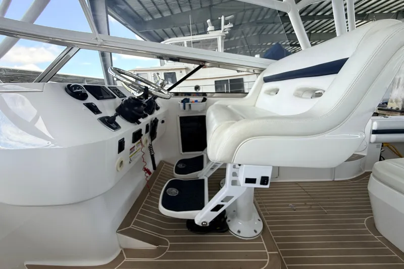 Slide: The Image of Helm of 2016 Intrepid 430 Sport Yacht with white seating and modern controls. - 15
