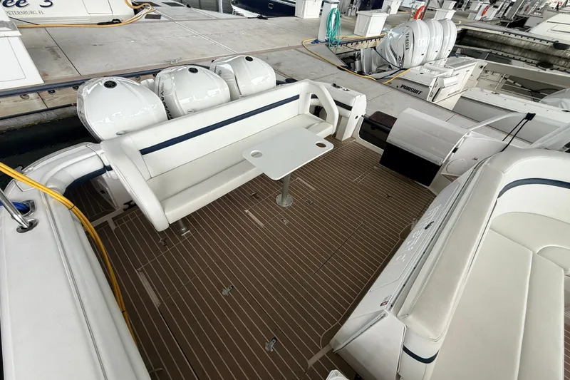 Slide: The Image of 2016 Intrepid 430 Sport Yacht deck with seating and table at marina. - 19