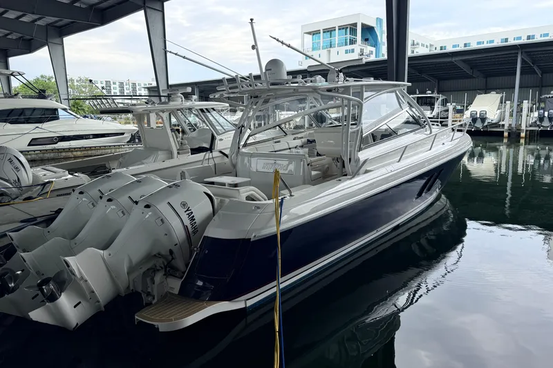 Slide: The Image of 2016 Intrepid 430 Sport Yacht docked with Yamaha engines in a marina. - 2