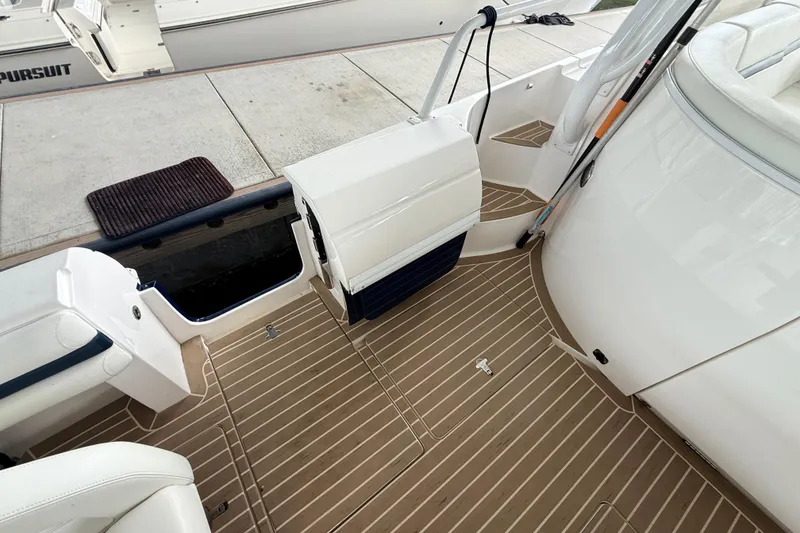 Slide: The Image of 2016 Intrepid 430 Sport Yacht deck with seating and storage compartments. - 20