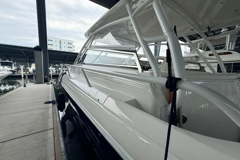 Slide: The Image of 2016 Intrepid 430 Sport Yacht docked at marina under cloudy sky. - 21
