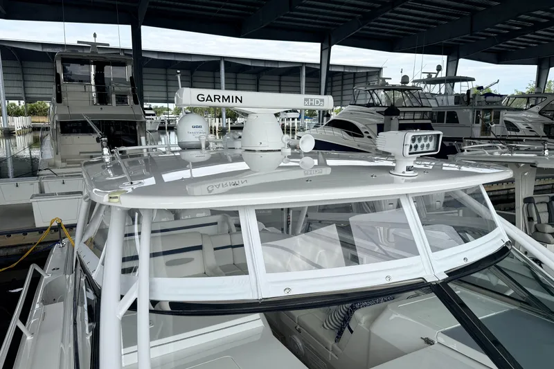 Slide: The Image of 2016 Intrepid 430 Sport Yacht with Garmin radar, docked in a covered marina. - 24