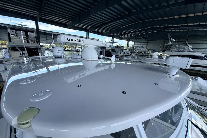 Slide: The Image of 2016 Intrepid 430 Sport Yacht with Garmin radar, docked in a covered marina. - 27