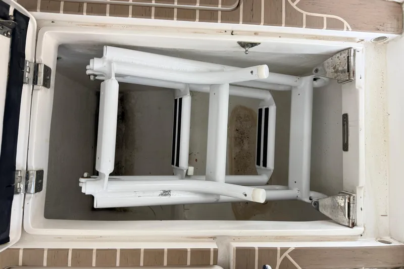 Slide: The Image of Storage compartment on a 2016 Intrepid 430 Sport Yacht, featuring a foldable ladder. - 29