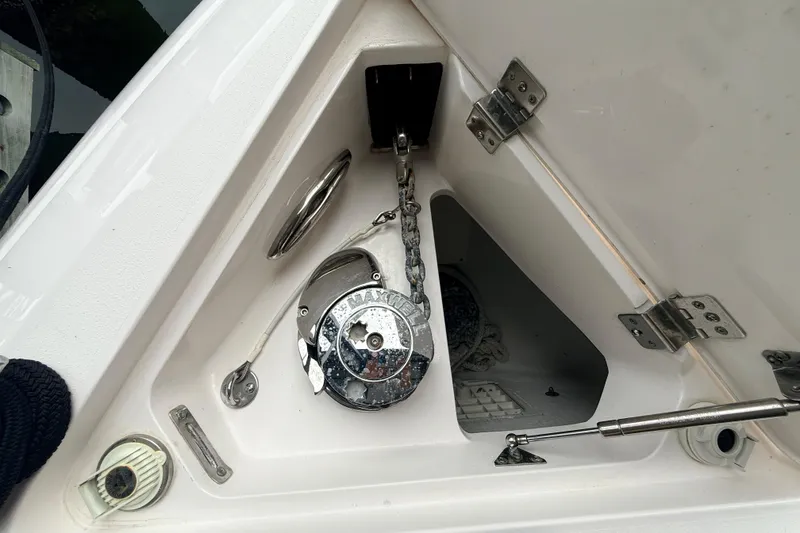 Slide: The Image of Anchor compartment of a 2016 Intrepid 430 Sport Yacht, featuring a windlass and chain. - 31