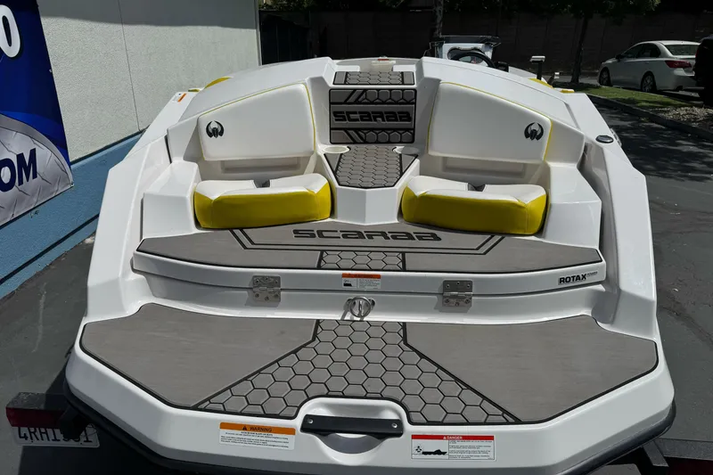 Slide: The Image of 2017 Scarab 165 G boat with yellow seating and hexagonal deck pattern. - 11