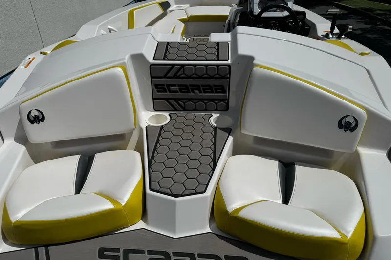 Slide: The Image of 2017 Scarab 165 G boat interior with white and yellow seating, hexagonal flooring. - 12