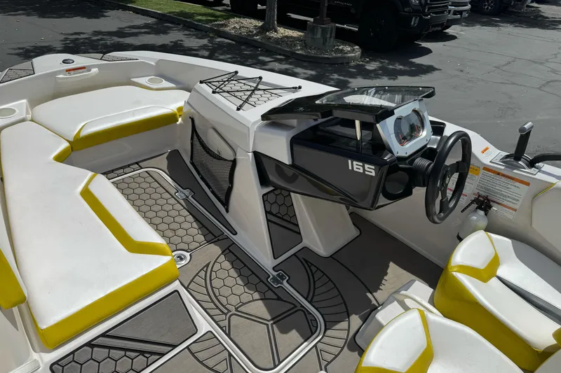 Slide: The Image of 2017 Scarab 165 G boat interior with yellow seating and modern dashboard. - 15