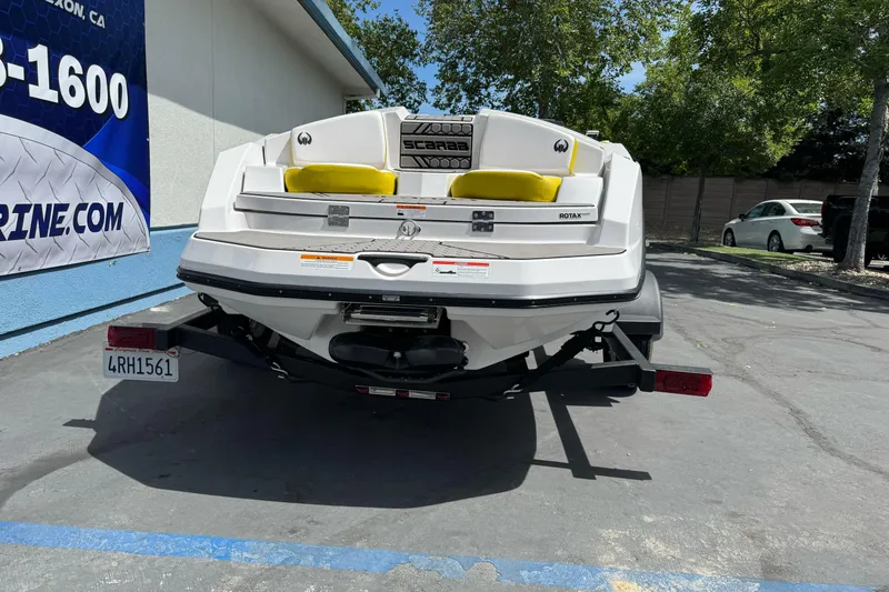 Slide: The Image of Rear view of a 2017 Scarab 165 G boat on a trailer, parked outdoors. - 3