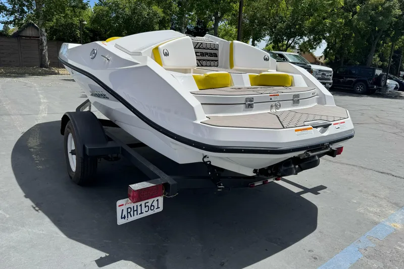 Slide: The Image of 2017 Scarab 165 G boat on trailer, parked outdoors, rear view. - 4