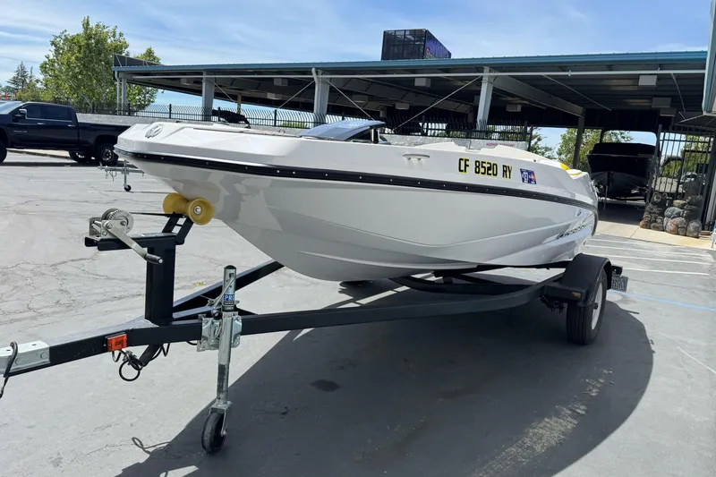 Slide: The Image of 2017 Scarab 165 G boat on trailer in parking lot, sunny day. - 5