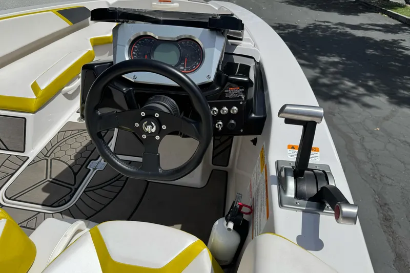 Slide: The Image of Cockpit of 2017 Scarab 165 G boat with steering wheel and controls. - 9