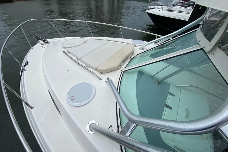 Slide: The Image of 2014 Wellcraft 340 Coastal boat deck with seating, docked on calm water. - 14
