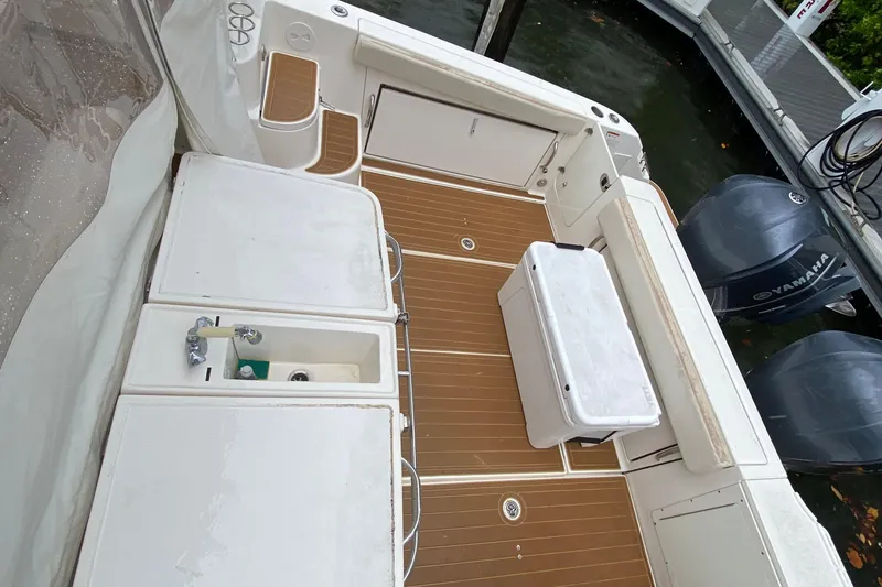 Slide: The Image of 2014 Wellcraft 340 Coastal boat deck with Yamaha engines and storage compartments. - 16