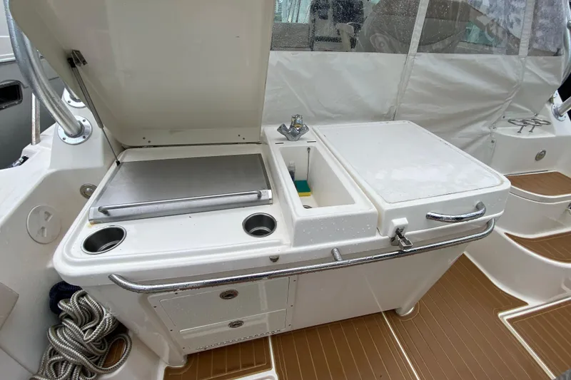 Slide: The Image of 2014 Wellcraft 340 Coastal boat interior with sink and storage area. - 17