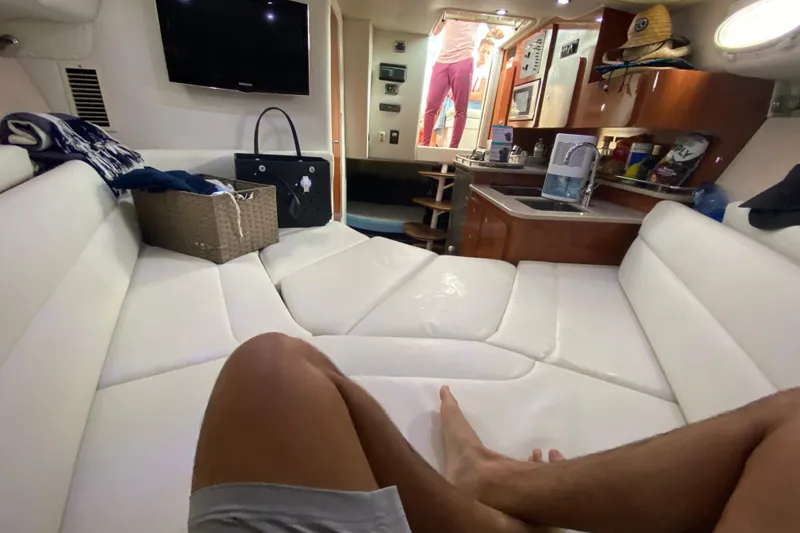 Slide: The Image of Interior of 2014 Wellcraft 340 Coastal boat with white seating and kitchenette. - 21