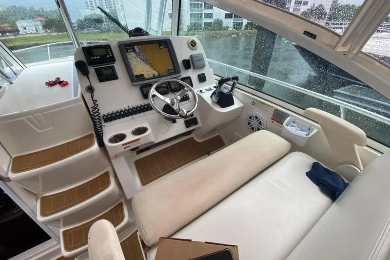 Slide: The Image of 2014 Wellcraft 340 Coastal boat cockpit with navigation system and steering wheel. - 24
