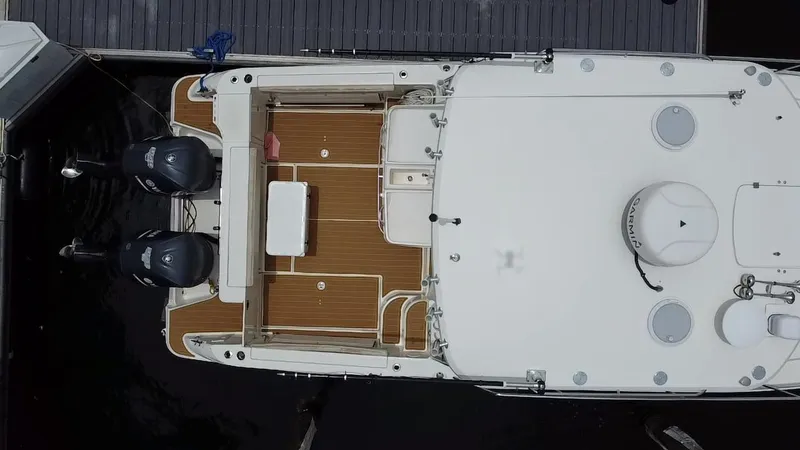 Slide: The Image of Aerial view of 2014 Wellcraft 340 Coastal boat docked, featuring twin outboard engines. - 9