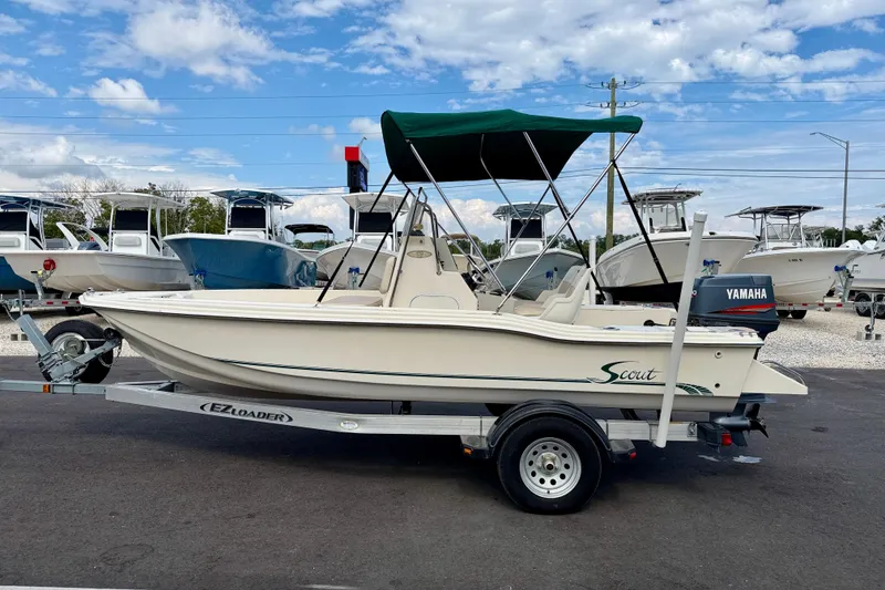 The Image of 2001 Scout 172 Sportfish boat on trailer with Yamaha motor, parked outdoors. - 0