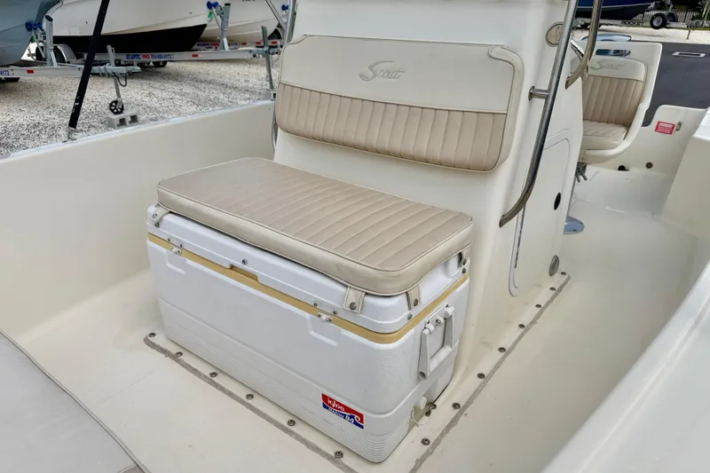Slide: The Image of 2001 Scout 172 Sportfish boat interior with beige seating and cooler storage. - 10