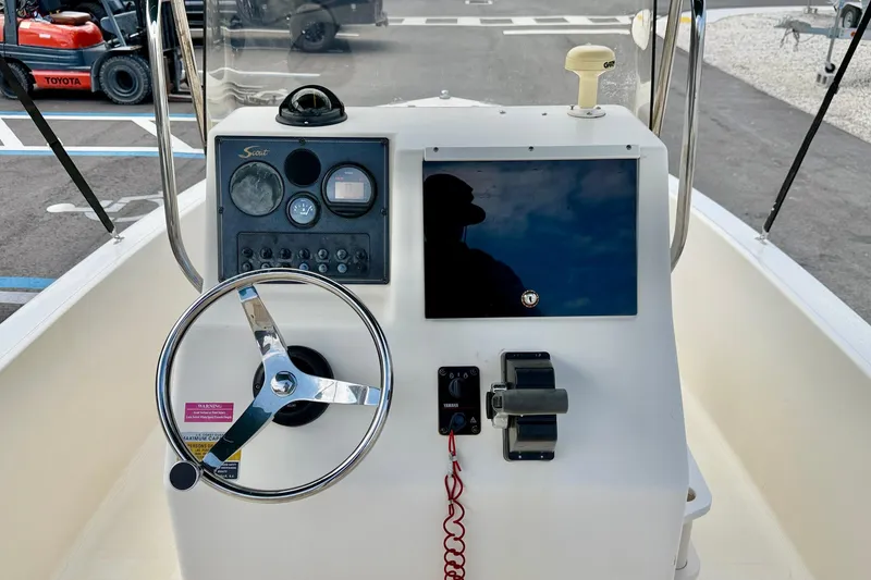 Slide: The Image of 2001 Scout 172 Sportfish boat dashboard with steering wheel and control panel. - 15