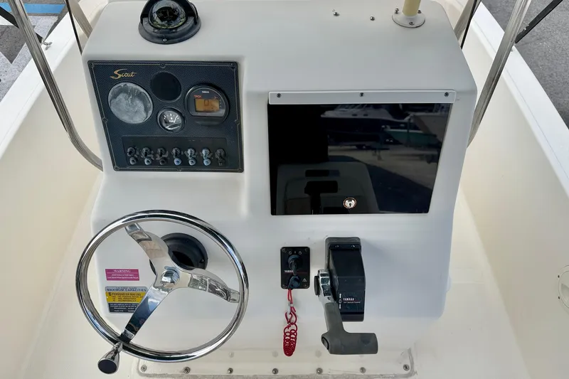 Slide: The Image of Console of a 2001 Scout 172 Sportfish boat with steering wheel and controls. - 16