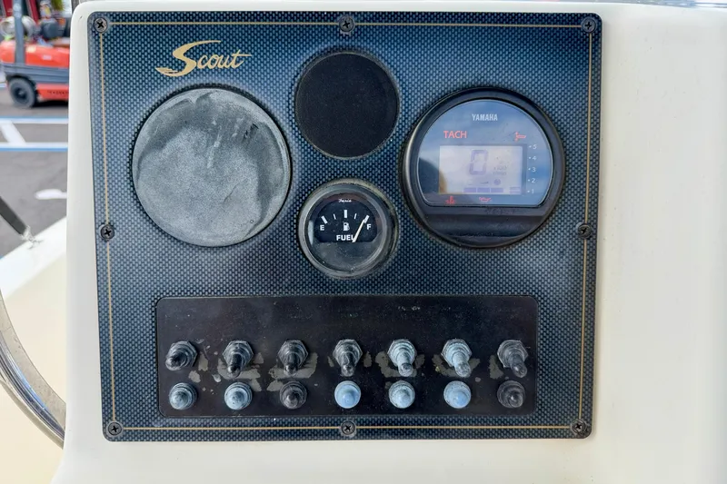 Slide: The Image of Dashboard of a 2001 Scout 172 Sportfish boat with gauges and switches. - 17