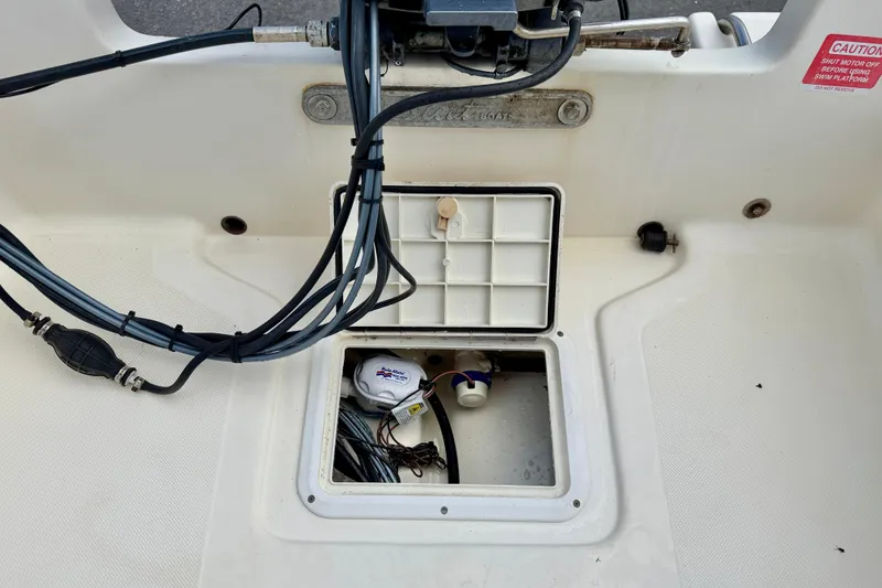 Slide: The Image of Open hatch on 2001 Scout 172 Sportfish boat showing internal wiring and components. - 24
