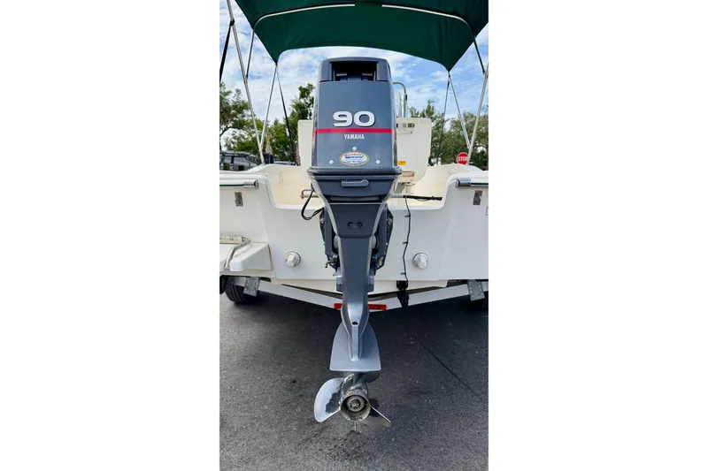 Slide: The Image of 2001 Scout 172 Sportfish boat with Yamaha 90 outboard motor, parked on trailer. - 28