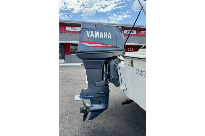 Slide: The Image of Yamaha outboard motor on a 2001 Scout 172 Sportfish boat, parked outdoors. - 29