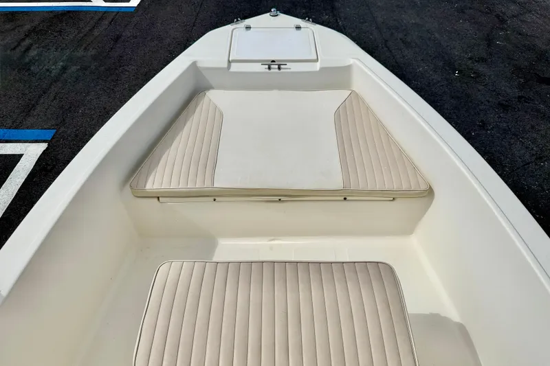 Slide: The Image of 2001 Scout 172 Sportfish boat interior with beige cushioned seating. - 9