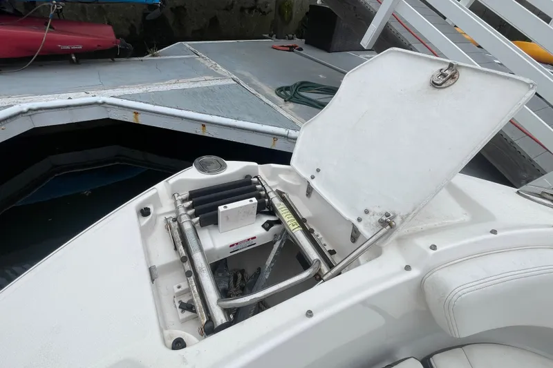 Slide: The Image of Open storage compartment on a 2014 Chaparral 224 Sunesta boat docked at a marina. - 10