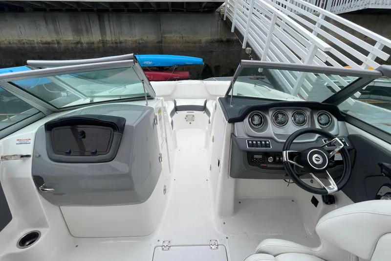 Slide: The Image of 2014 Chaparral 224 Sunesta boat interior with steering wheel and dashboard controls. - 11