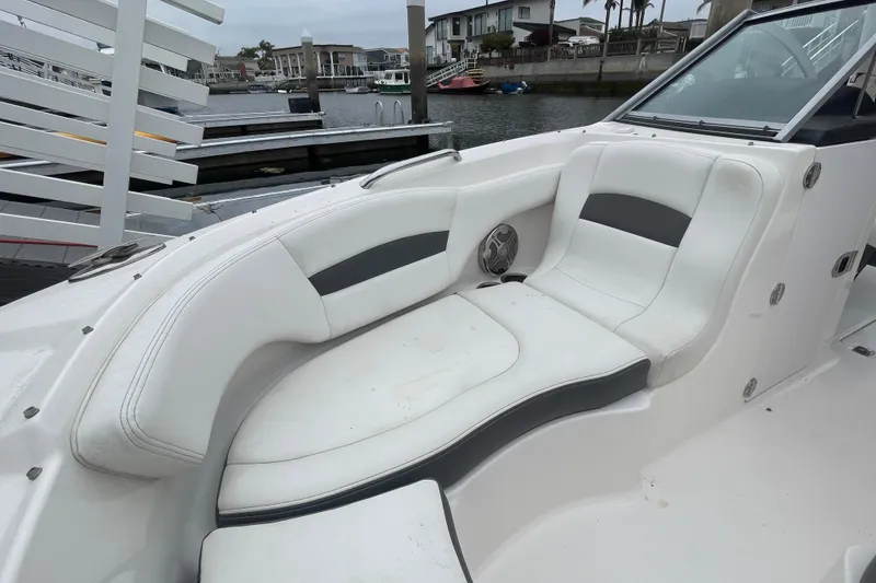 Slide: The Image of 2014 Chaparral 224 Sunesta boat interior with white seating and waterfront view. - 14