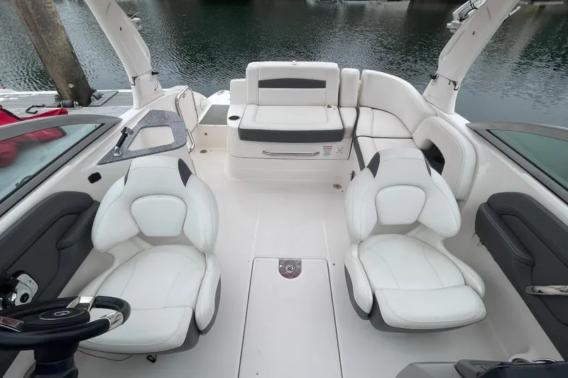Slide: The Image of Interior of a 2014 Chaparral 224 Sunesta boat with white seating and steering wheel. - 16