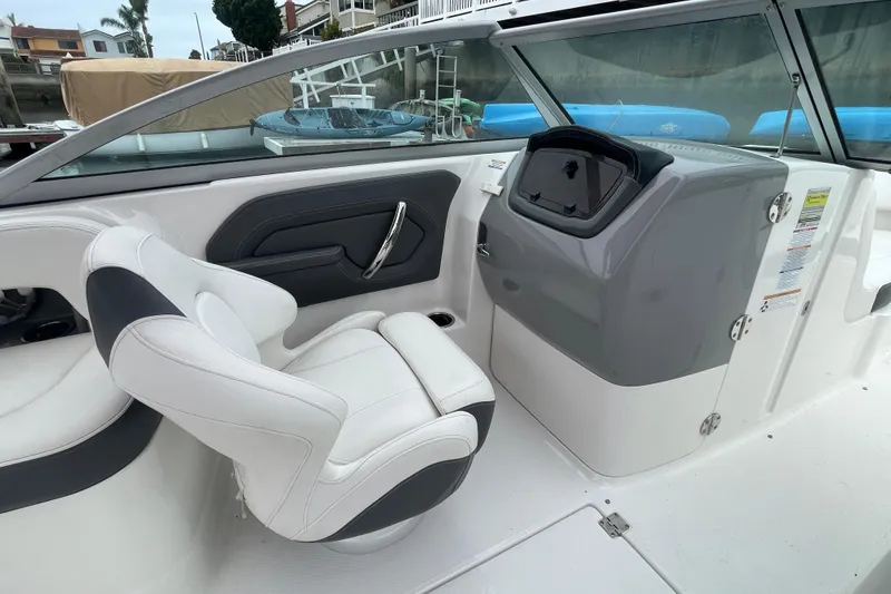 Slide: The Image of 2014 Chaparral 224 Sunesta boat interior with white seating and dashboard. - 17
