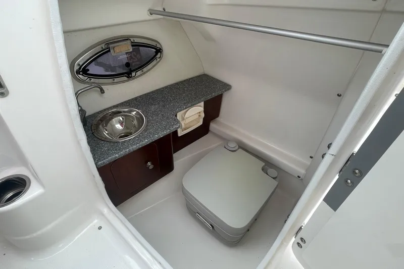 Slide: The Image of 2014 Chaparral 224 Sunesta boat interior with sink and portable toilet. - 19