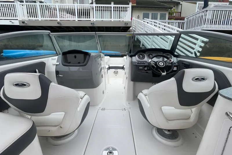 Slide: The Image of 2014 Chaparral 224 Sunesta boat interior with steering wheel and seating. - 20