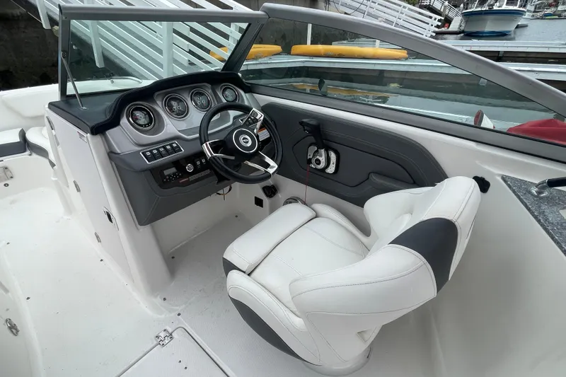Slide: The Image of 2014 Chaparral 224 Sunesta boat cockpit with steering wheel and gauges. - 22