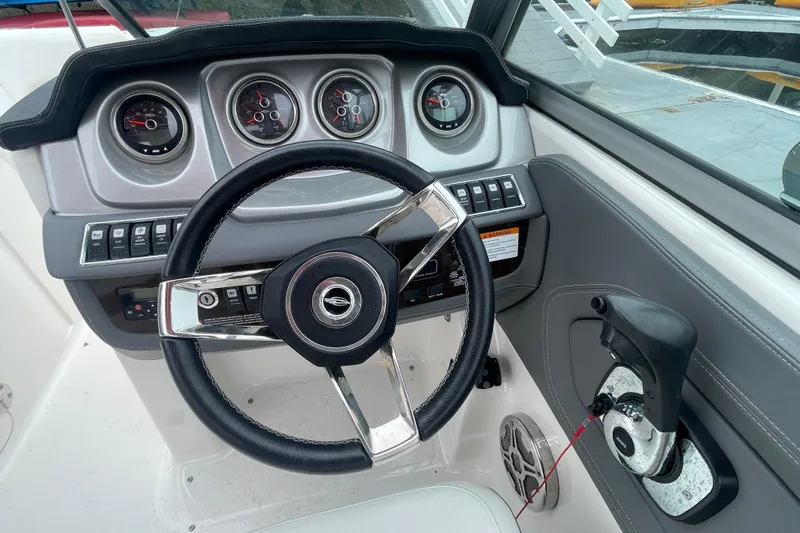 Slide: The Image of Steering console of a 2014 Chaparral 224 Sunesta boat with gauges and controls. - 24