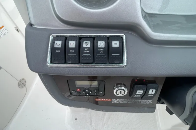 Slide: The Image of Control panel of a 2014 Chaparral 224 Sunesta boat with labeled switches. - 26