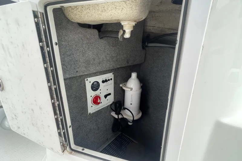 Slide: The Image of Storage compartment of a 2014 Chaparral 224 Sunesta boat with control panel and equipment. - 29