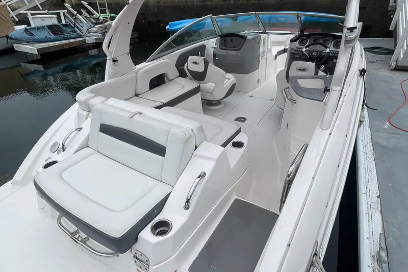 Slide: The Image of 2014 Chaparral 224 Sunesta boat interior with white seating and modern dashboard. - 36