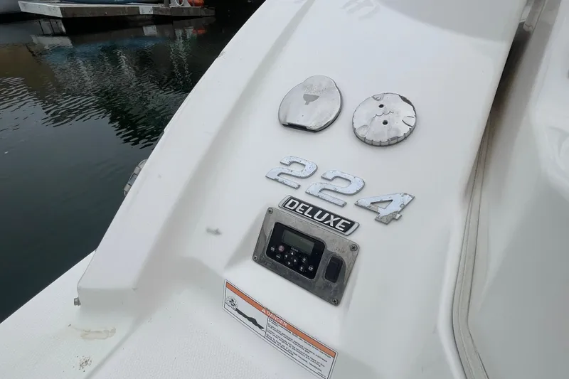 Slide: The Image of 2014 Chaparral 224 Sunesta boat with deluxe badge and control panel by the water. - 38